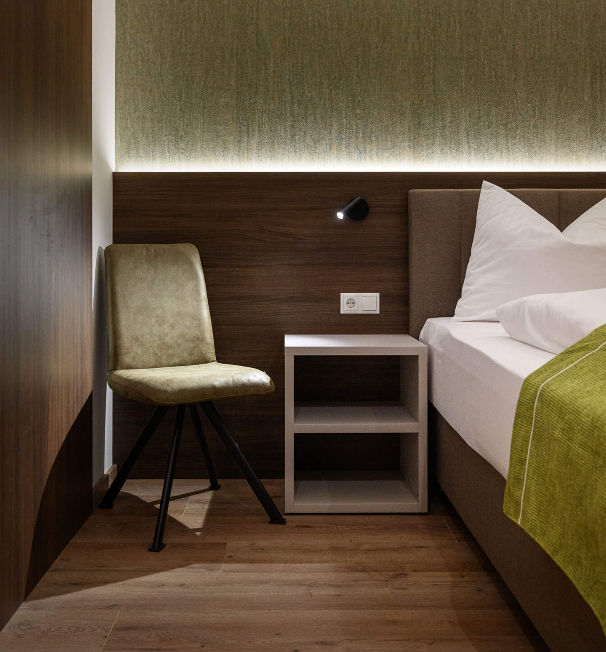 Chair and bedside table in the bedroom of Sambock Quarter Apartment - PustraBase